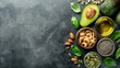 Healthy fats food selection with avocado, nuts, seeds, and olive oil, top view with copy space for add text.