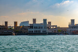 Fototapeta Mapy - Contrast of Ancient Wind Towers and Modern Construction at Dubai Creek