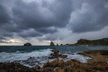 Stony coast with sharp rock formations on a bay in the sea. rainy sunrise, dramatic mood. Pointe des Chateau overlooking Pointes des colibris on Grande Terre, Guadeloupe, French Antilles, Caribbean