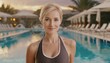 © Marko - Attractive short haired blond mature woman posing in swimsuit looking at the camera at a resort swimming pool area