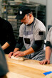 close-up in professional kitchen inclusive worker shaping dough on the table