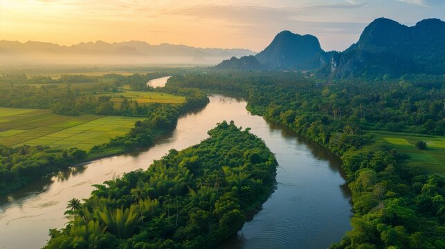 Beautiful natural scenery of river in southeast Asia tropical green forest with mountains in background, aerial view drone shot