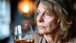 A beautiful middle-aged woman is sitting at home drunk alone with a glass of alcohol