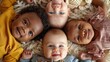 © AdriFerrer - Five babies of different ethnicities lying down together.