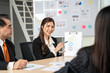 © Bavorndej - A focused businesswoman explains the Environmental, Social, and Governance (ESG) principles to a colleague during a corporate meeting.