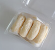 A clear plastic container filled with frozen rice cake bars, a popular Asian snack or ingredient.Packaged Frozen Rice Cake Bars.