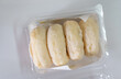 A clear plastic container filled with frozen rice cake bars, a popular Asian snack or ingredient.Packaged Frozen Rice Cake Bars.