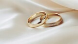 Fototapeta Do przedpokoju - Wedding rings on white satin background, close-up
