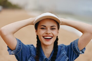 Wall Mural - Happy Young Woman, Portrait of an Attractive Caucasian Lady in Fashionable Summer Hat, Smiling and Laughing Outdoors with Nature Background