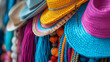 Colorful straw hats on display at outdoor flea market in a tropical island.