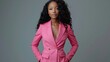 An elegant businesswoman in a stylish pink pantsuit stands confidently, her posture poised and professional