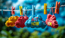 Cloud-shaped Paper Cutouts With The Words ACT NOW Hanging On A String With Colorful Clothespins Against A Blue Background, Concept Of Urgency And Call To Action
