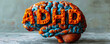 A three-dimensional human brain model with the orange letters ADHD representing Attention Deficit Hyperactivity Disorder, on a neutral background