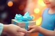 Hands giving and receiving present. Male and female hands holding gift box on blurred background. Birthday, Valentine's day, Christmas, New Year, Father's and Mother's day