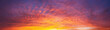 Dramatic dusk sky with clouds. Mysterious abstract heaven background pattern texture at sunset.  Wide banner panorama.