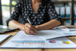 © Maksym - Analyzing Business Data: A Professional Reviewing Graphs and Charts