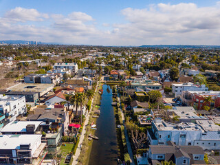 Wall Mural - Aerial drone view over Venice Canals Historic District  looking east on a partly cloudy day in Los Angeles, california.