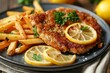 Close up of a plate with fried veal cutlet Milanese lemon and French fries on a table