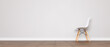 White chair with wooden legs, in a lateral position, close to a wall, on a parquet floor. Place for text, mockup, copy space. Minimal concept. 3d illustration.