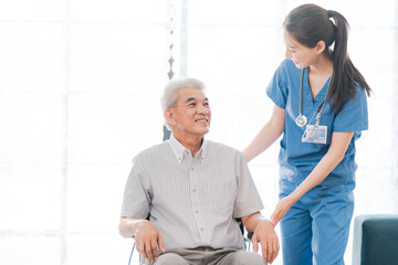 asian woman doctor nursing home to helping take care to retirement patient who sitting on wheelchair, caregiver nurse support to medical health care insurance at home or hospital, elderly senior man