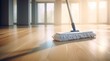 A mop on a wooden floor in a room.
