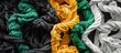 Various twisted cotton ropes of different colors such as black, white, yellow, and green are tangled together, creating a mishmash of fishing ropes in this image.