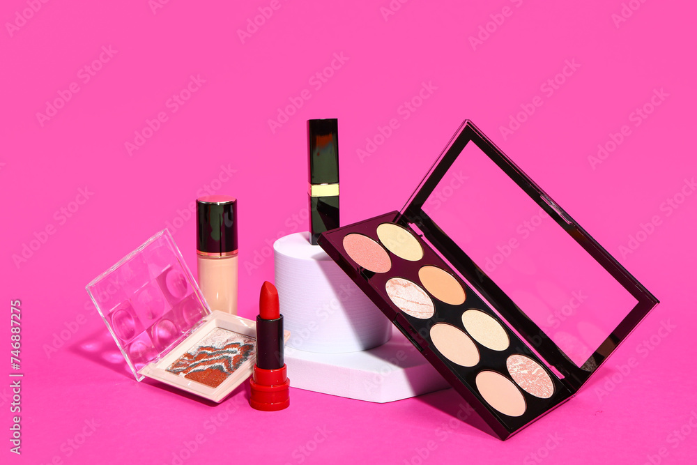 Different makeup cosmetics on pink background