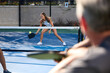 © joescarnici - A man watches as a woman hits a forehand during a pickleball game