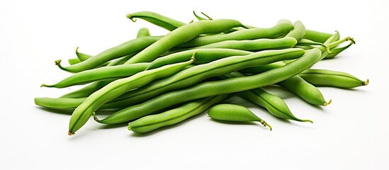 Sticker - A bunch of fresh green beans arranged neatly on top of a clean white table surface. The vibrant green colors of the beans stand out against the bright background.