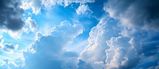 Wall Mural - Tranquil Blue Sky with Fluffy Clouds and Sunlight, Serene Nature Background