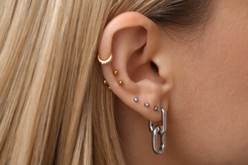 Woman with multiple ear piercing, closeup