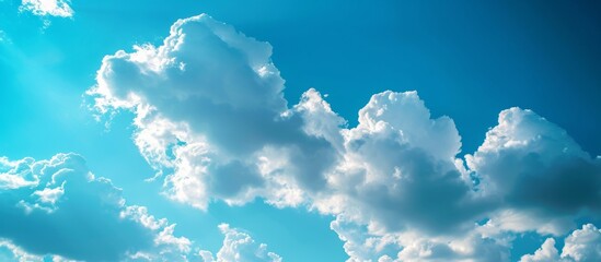 Wall Mural - serene blue sky with fluffy white clouds, nature's peaceful canvas