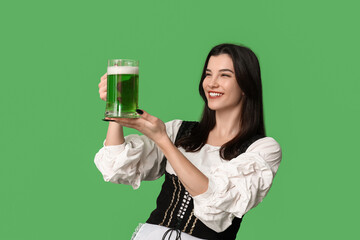 Poster - Irish waitress with glass of beer on green background. St. Patrick's Day celebration