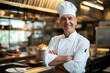 With a white toque atop their head, a chef beams with confidence in a vibrant commercial kitchen, embodying the culmination of years dedicated to mastering the art of cooking.
