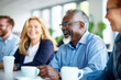 © SnapVault - A diverse group of mature professionals taking a break with a cup of coffee with a positive attitude in an office environment.