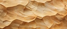 A Close-up View Of A Towering African Desert Sandstone Rock Formation Creates A Brown Textured Effect Against A Clear Sky Background. The Intricate Details Of The Rocks Are Highlighted Under The