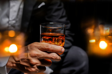 Wall Mural - Closeup businessmen holding a glass of whiskey