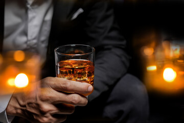 Wall Mural - Closeup businessmen holding a glass of whiskey