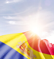 Wall Mural - Andorra flag in waving in beautiful sky with sunlight.