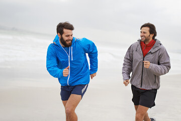 Wall Mural - Laugh, men and running on beach, sand and fitness for wellness and gym wear on ocean coast workout. Male athletes, jog and training for seaside, health and outdoor for sport and exercise together