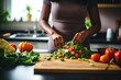 © shelbys - A woman is cutting up vegetables on a cutting board in the kitchen