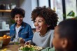 © shelbys - A Smiling Little Boy and Girl Share a Meal with Their Plates of Food at a Kitchen Table