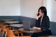 © Thinapob - asian freelance people businesswoman talking making using smartphone casual working with laptop computer in cafe coffee shop background,business expressed confidence embolden and successful concept