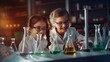 Two girls in lab, smiling, looking at beakers filled with liquid