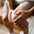 © RDO - Knee Pain While Climbing Stairs - An individual hesitantly ascending stairs, pausing to grasp their knee with a look of concern.