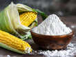 bowl with corn starch on kitchen table and ear of corn.