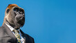 Gorilla in formal suit with striped pattern and tie on bright blue sky background