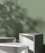 © Sue Tansirimas - Three gray triangle terrazzo pedestal table podium in dappled sunlight, leaf foliage shadow on green wall for luxury organic cosmetic, skincare, body care, beauty product background 3D