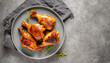 © Chidori_studio - Grilled chicken Leg, bbq chicken legs. top view of grilled chicken legs on grey dish, copy space