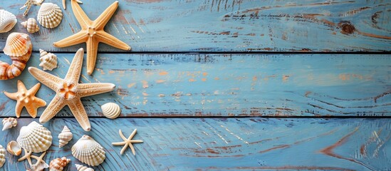 Wall Mural - Seashells and starfish arranged on a electric blue wooden table, creating a beautiful pattern of nature and art. The wood and water elements blend harmoniously in this event of coastal decor.